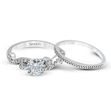Playful and modern, this white gold wedding set sparkles with .31 ctw of round white diamonds highlighting the center stone.