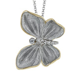 Symbolizing transformation, this butterfly pendent crafted in 18K white and yellow gold and accented by .06cttw diamonds is the perfect addition to any jewelry collection.