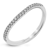 The modern style of this white gold ring is complemented by .44 ctw of glistening baguette cut white diamonds and .36 ctw of round cut white diamonds.