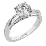 This twist engagement ring in 18 kt white gold takes a 1.5 ctw center, and features tapered baguette sides 0.52 ctw.