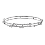 This whimsical bangle in 18K white gold features 1.80 ctw of bezel set diamonds, that appear to be suspended on a wire