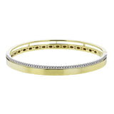 This stunning yellow gold bangle has a matte finish and is accented by a row of white diamonds 0.32 ctw., along its edge.