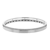 This stunning white gold bangle has a matte finish and is accented by a row of white diamonds 0.32 ctw., along its edge.