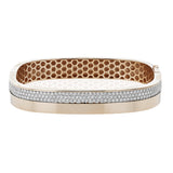 This modern18K two tone bangle in a square design has a brushed rose gold finish on the bottom, and 3 rows of pave set diamonds 1.60 ctw on the top.