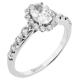 This 18K white gold antique design features a scalloped diamond halo which gives the ring a floral effect, and flush set side diamonds 0.48ctw, made for an oval center stone