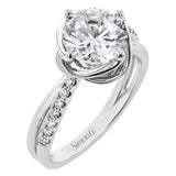 This criss-cross design engagement ring shimmers with 0.15 ctw round diamonds and a halo of gold strands wrapped around the center