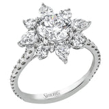 Pear shaped diamonds are set into a pointed halo that expands outward like a cosmic explosion in this Supernova Collection engagement ring.