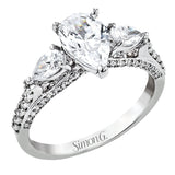 Pear shaped side stone set horizontally give this 18k white gold engagement ring a modern feel, accentuating the pear shape center stone.
