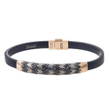 This men's bracelet features a pattern made from 14k yellow gold and titanium set with .57 ctw of black diamonds.