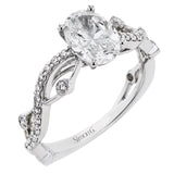 The intertwined design of this 18k gold engagement ring perfectly offsets an oval shaped center stone.