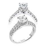 Shining white diamonds encircle the center stone in this Underhalo engagement ring, while also extending across the sides of the ring to ensure it glitters from all directions.
