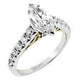 A touch of 18k yellow gold filigree on the interior of this ring adds a special touch to this 18k white gold engagement ring made for a marquise shape center stone.