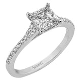 Simple yet stunning, this graceful engagement ring is made for a princess cut center stone and is set with .16 ctw of white diamonds.