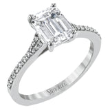 Simple yet stunning, this graceful engagement ring is made for an emerald cut center stone and is set with .16 ctw of white diamonds.