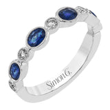 This lovely 18k white gold band is perfect for stacking but can also stand on its own. Blue sapphires are paired with .15 ctw of diamonds.