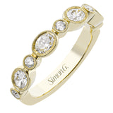 This lovely 18k yellow gold band is perfect for stacking but can also stand on its own. Beautiful green emeralds are paired with .15 ctw of diamonds.