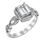 Reflecting a lovely romantic design, this white gold classic engagement ring features .16 ctw round cut white diamond accents.