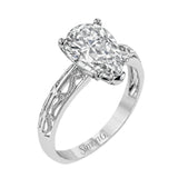 A whimsical openwork design glimmers with .04 ctw of round white diamonds in this charmingly beautiful white gold engagement ring.