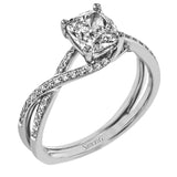 This sparkling modern engagement ring features an eye-catching twisted design with elegant classic halo accented by .29 ctw of shimmering round cut white diamonds.