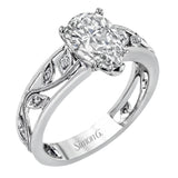 A delicate floral design highlights this vintage style engagement ring accented by .09 ctw of shimmering round cut white diamonds.