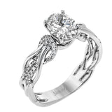 This impressive contemporary white engagement ring features a unique twisting design on the shank, which is complemented by .17 ctw of round cut white diamonds.
