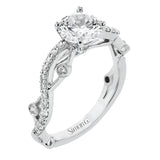 A modern, unique design, this 18k gold engagement ring featuring an intertwined design set with .22 ctw of white diamonds.