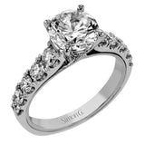 A beautiful row of .86 ctw of significant diamonds leads up to the center stone in this timeless engagement ring design.