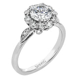 This stunning, contemporary design features .36 ctw of round white diamonds set in its exaggerated halo and delicate side details to evoke a charming floral motif.