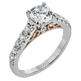 This beautiful white gold engagement ring is set with .55 ctw of round white diamonds flanking the center stone, as well as a distinctive rose gold accent