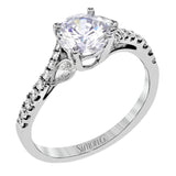 This lovely 18k white gold engagement ring contains .20 ctw of white round brilliant diamonds, highlighted by .10 pear shaped white diamonds.