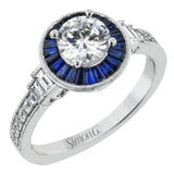 This 18k white gold engagement ring add something special with .46 ctw of baguette sapphires in a halo around the center stone. A total of .13 ctw of white diamonds and an additional .13 ctw of baguette diamonds finish this remarkable design.
