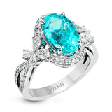This ring is truly extraordinary, centering around an incredibly bright 4.04 ctw paraiba tourmaline. This is surrounded by .31 ctw of round diamonds and .66 ctw of pear shaped diamonds set into nature inspired elements crafted in 18k white gold.