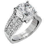 This bold 18k white gold engagement setting contains 1.04 ctw of princess cut diamonds alongside .40 ctw of round brilliant diamonds.