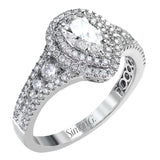 Featuring a pear-shaped double halo, this modern white gold engagement ring is highlighted by .68 ctw of round cut white diamonds.