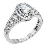 Featuring an exquisite contemporary design, this white gold engagement ring features an eye-catching oval double halo complemented by .68 ctw of round cut white diamonds.
