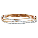 Featuring a distinctive contemporary design, this twist style bracelet is accentuated with 1.51 ctw of shimmering white diamonds in a dazzling white and rose gold setting.