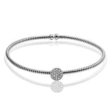 This dazzling modern white gold bangle bracelet is accentuated by an open design and highlighted with a lovely oval setting complemented with .15 ctw round cut white diamonds.