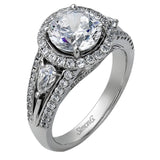 Reflecting a charming vintage design, this dazzling white gold engagement ring features .63 ctw of round cut white diamonds and .51 ctw of pear shaped white diamonds.