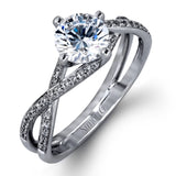 This sparkling modern white gold engagement ring and wedding band set features an eye-catching twisted design accented by .22 ctw of shimmering round cut white diamonds.