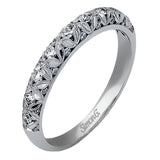 This intricate band has a floral, nature-inspired design and contains .32 ctw of white diamonds.
