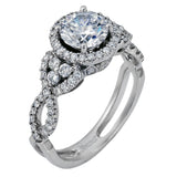 Reflecting an intricate modern design, this remarkable white gold ring is emphasized by a lovely halo complemented with .59 ctw round cut white diamonds.