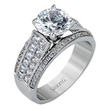 This impressive modern white gold ring features .18 ctw of glimmering round cut white diamonds accentuated by .97 ctw princess cut diamonds.