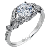 This lovely modern white gold engagement ring features a memorable halo and is accentuated by .19 ctw glistening round cut white diamonds.
