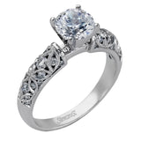 Featuring a delicate floral design, this white gold vintage engagement ring is set with .35 ctw of shimmering white diamonds.