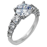 This white gold engagement ring's sophisticated, contemporary design glitters with 1.14 ctw of round white diamonds flanking the center stone.