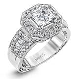 The dramatic contemporary design of this white gold ring is highlighted by .59 ctw of round cut white diamonds and .36 ctw princess cut diamonds.