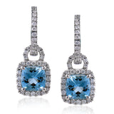 These stunning earrings feature cushion cut Aquamarines 1.53 ctw., surrounded by a halo of diamonds that dangle from diamond huggies 0.45 ctw