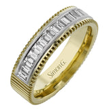 A striking 18K two toned ring with a ribbed yellow gold band and a row of baguette diamonds 0.59 ctw., in a delicate white gold beaded channel