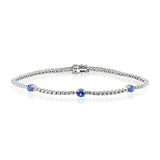 This eminently wearable 18k white gold bracelet features three blue sapphire accents that total .60 ctw.