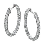 A full 1.00 ctw of diamonds line both in the inside and outside of these remarkable 18k white gold hoop earrings.